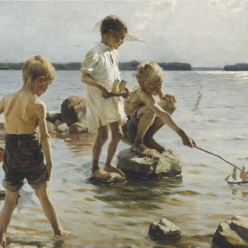 Three boys playing in shallow water by the shore, one holding a toy boat and the others engaged in playful activities on rocks.