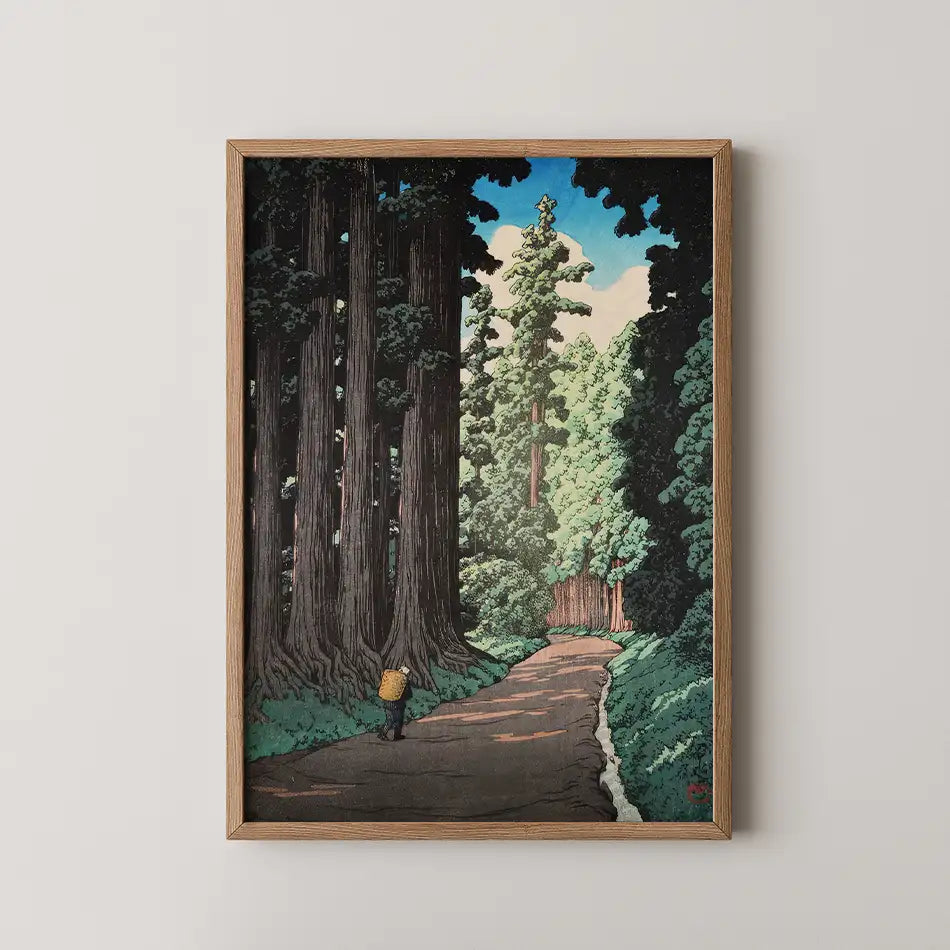 Framed painting of a scenic forest pathway surrounded by tall trees and a clear blue sky.