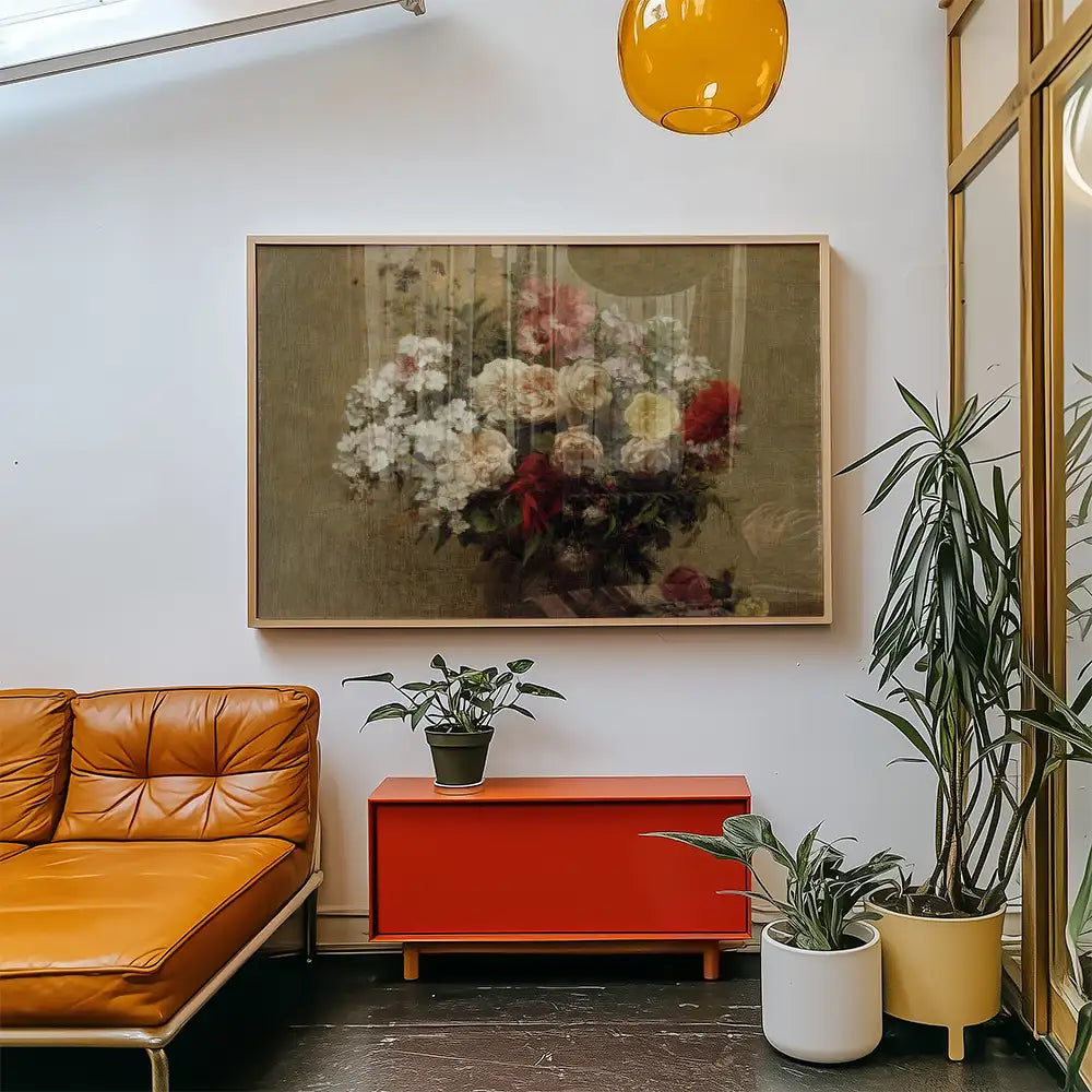 Painting of a floral bouquet in a framed canvas displayed in a modern living room setting with orange sofa and decorative plants.