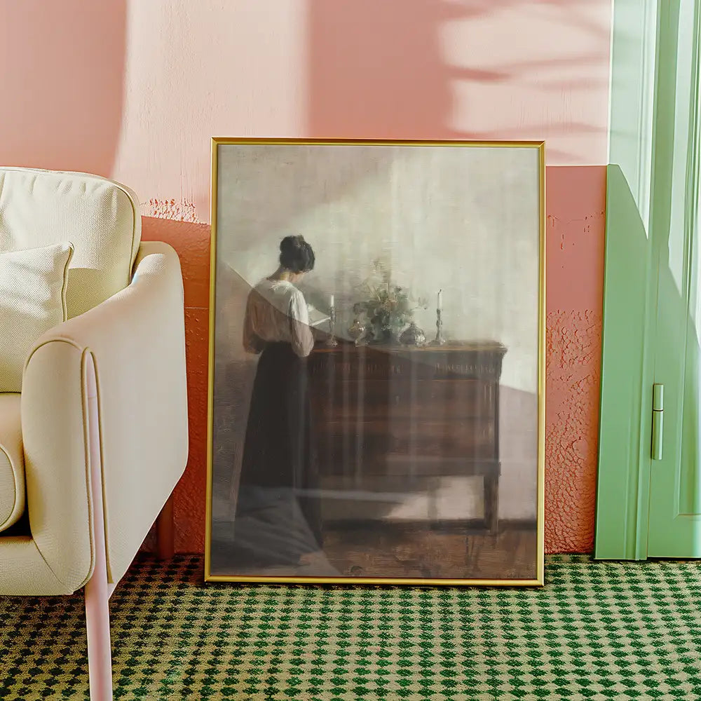 A framed painting of a woman standing next to a wooden dresser adorned with flowers and candles, set against a pastel pink wall and green door in a cozy interior.