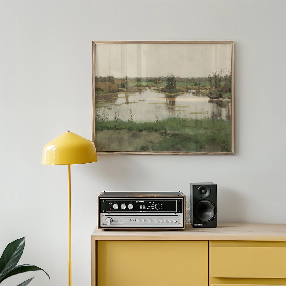 Framed landscape painting above a yellow floor lamp and a vintage audio system on a wooden cabinet.