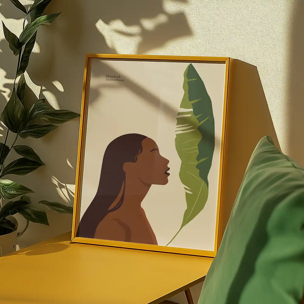 Modern poster reprint of a famous painting featuring a silhouette of a woman beside a large green leaf, showcased in a stylish yellow frame on a bright table setting.