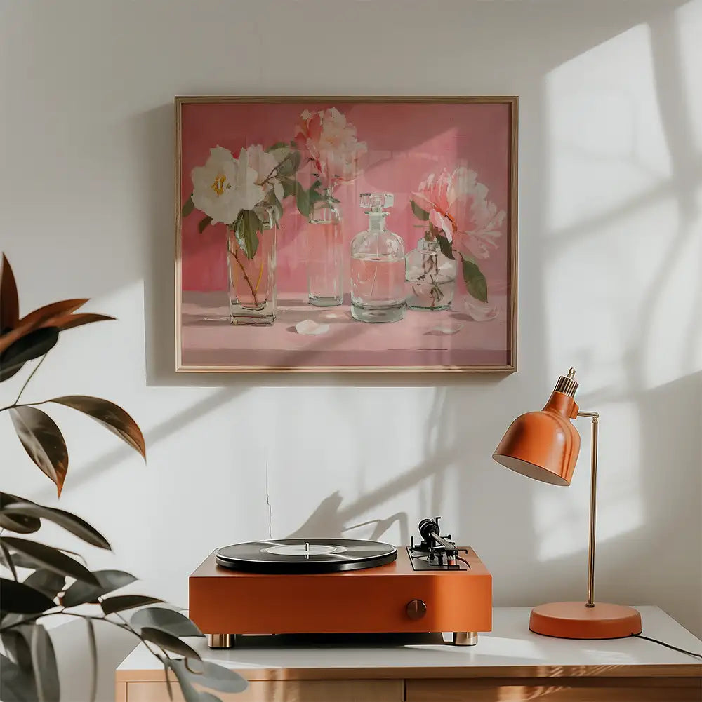 A vibrant painting of flowers in glass vases against a pink background, displayed above an orange turntable and lamp in a cozy interior setting.