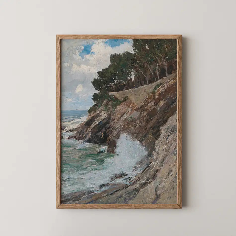 Painting of a rocky coastline with crashing waves and lush greenery, framed in natural wood.