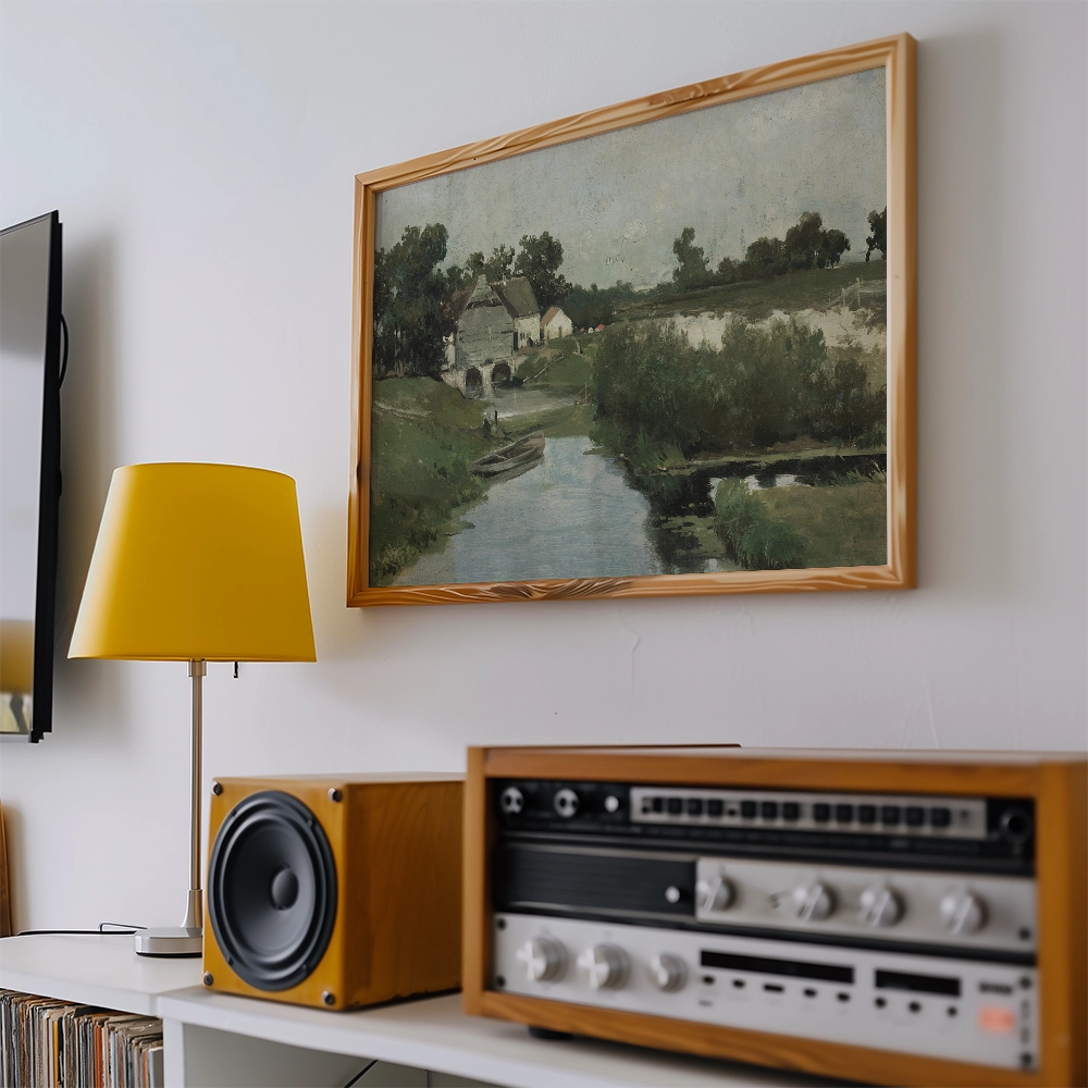 A serene landscape painting displayed on a wall, featuring a river, greenery, and a quaint house, alongside a yellow lamp and a vintage audio setup.