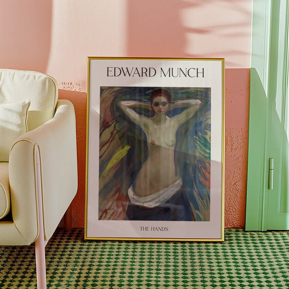 Framed painting titled "The Hands" by Edward Munch, depicting a figure with raised arms against an abstract colorful background, displayed in a modern interior setting.
