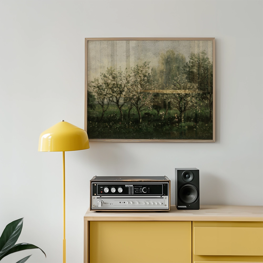 Framed painting of a serene landscape with trees hanging above a modern yellow lamp and a vintage audio system on a light-colored wooden cabinet