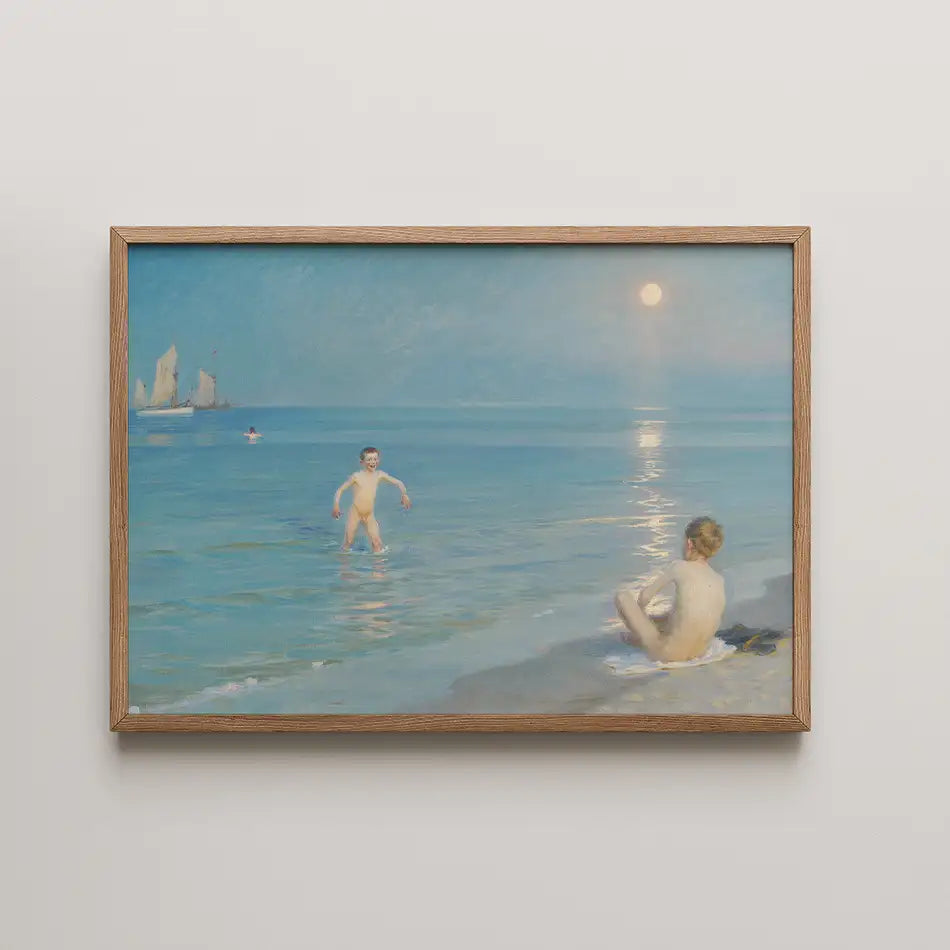 Painting of two children by the seaside, one playing in the water and the other sitting on the beach, with a serene blue sky and gentle waves, framed in wood.