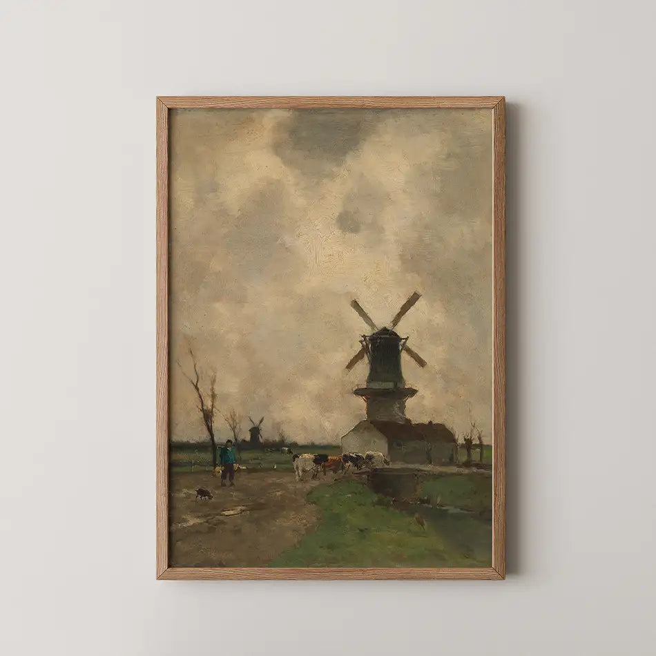 Framed painting of a countryside scene featuring a windmill, cows, and people walking on a dirt path under a cloudy sky.