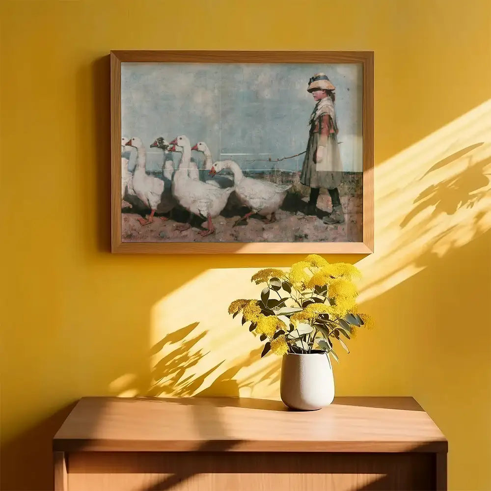 Painting of a child walking a group of geese, framed and displayed on a yellow wall above a wooden cabinet with a vase of yellow flowers.