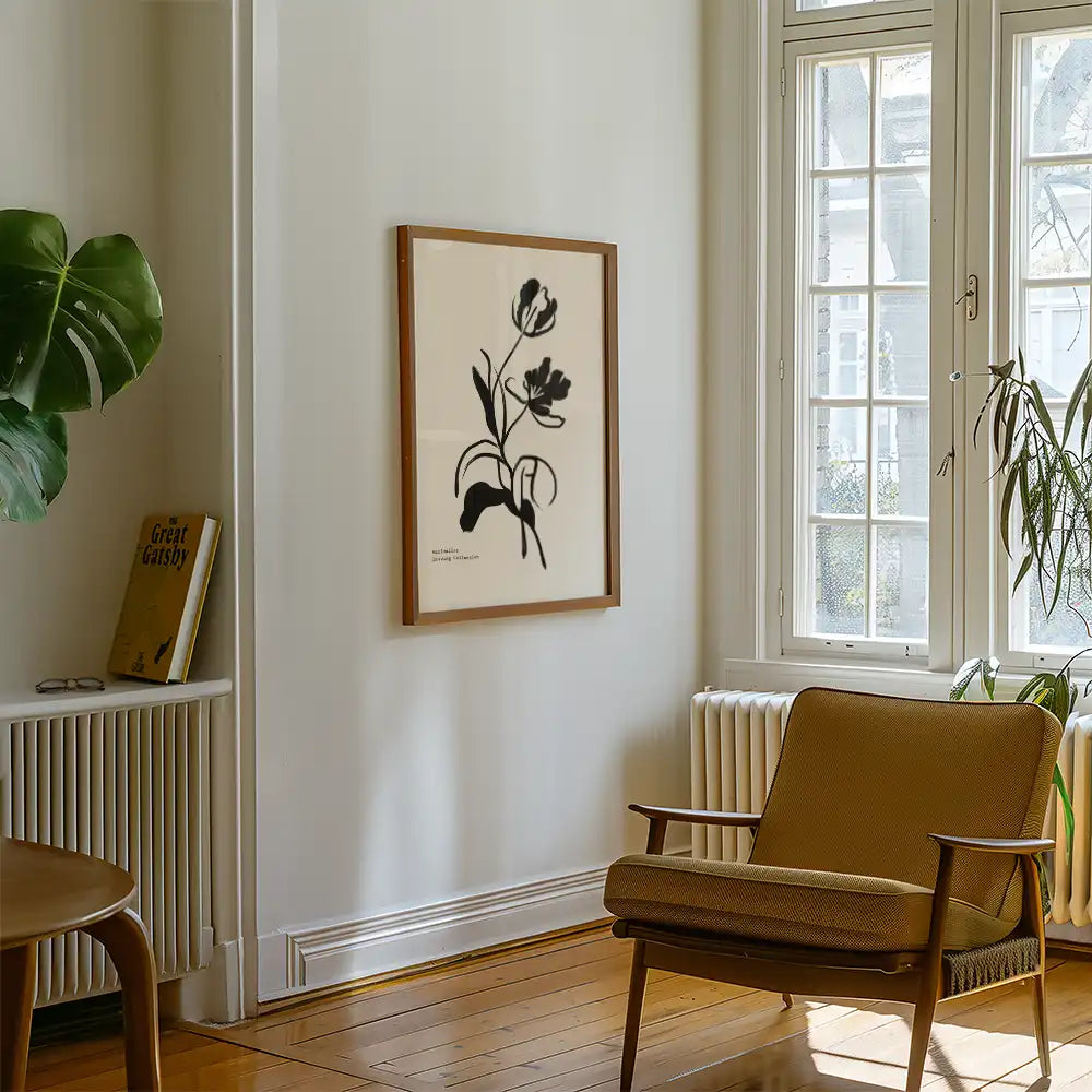 Modern reprint of a famous painting featuring a black floral silhouette in a stylish frame, displayed in a cozy interior with natural light and minimalist decor.