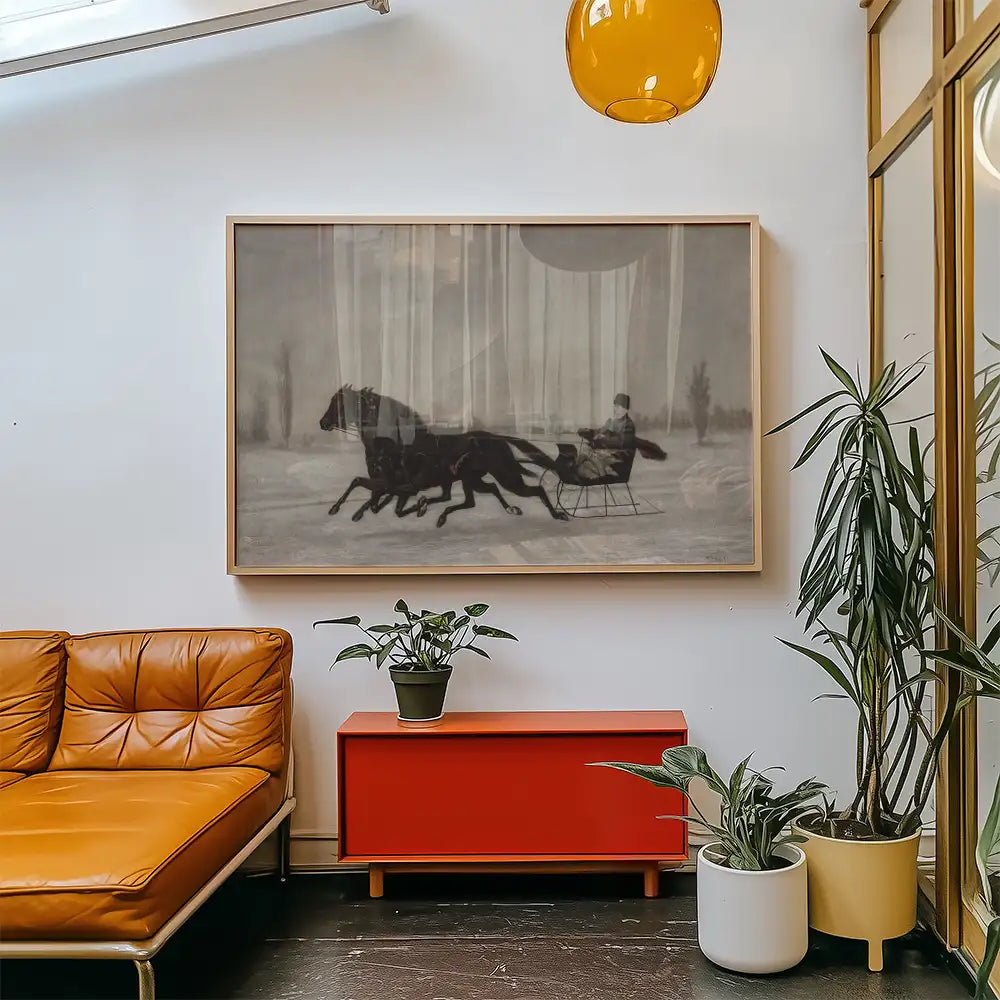 Black and white painting of a horse-drawn sleigh with a rider, framed and displayed above an orange couch and red cabinet in a modern living room setting.