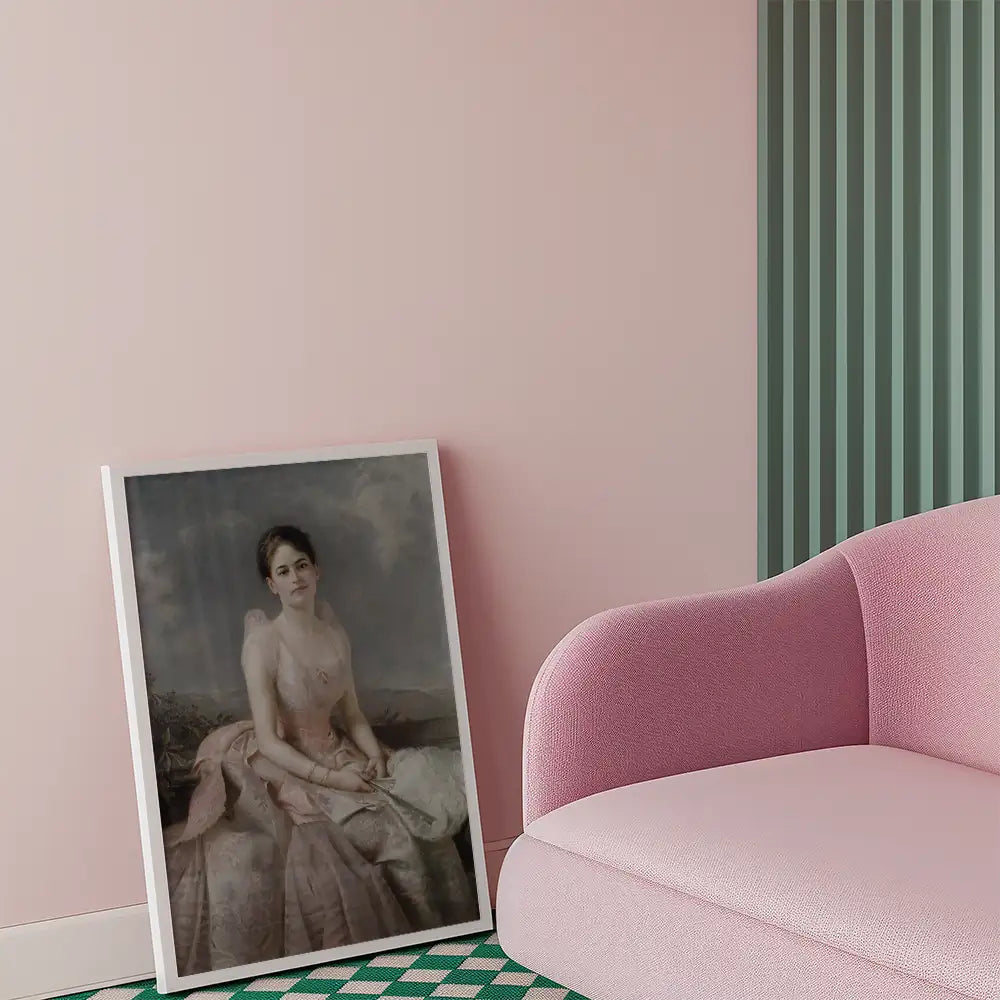 Framed painting of a woman in a pink dress leaning against a wall, positioned next to a pink couch.