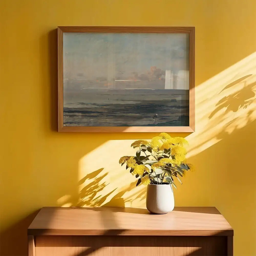 Framed painting of a serene landscape with a blue sky and ocean, displayed on a vibrant yellow wall above a vase of yellow flowers on a wooden table.