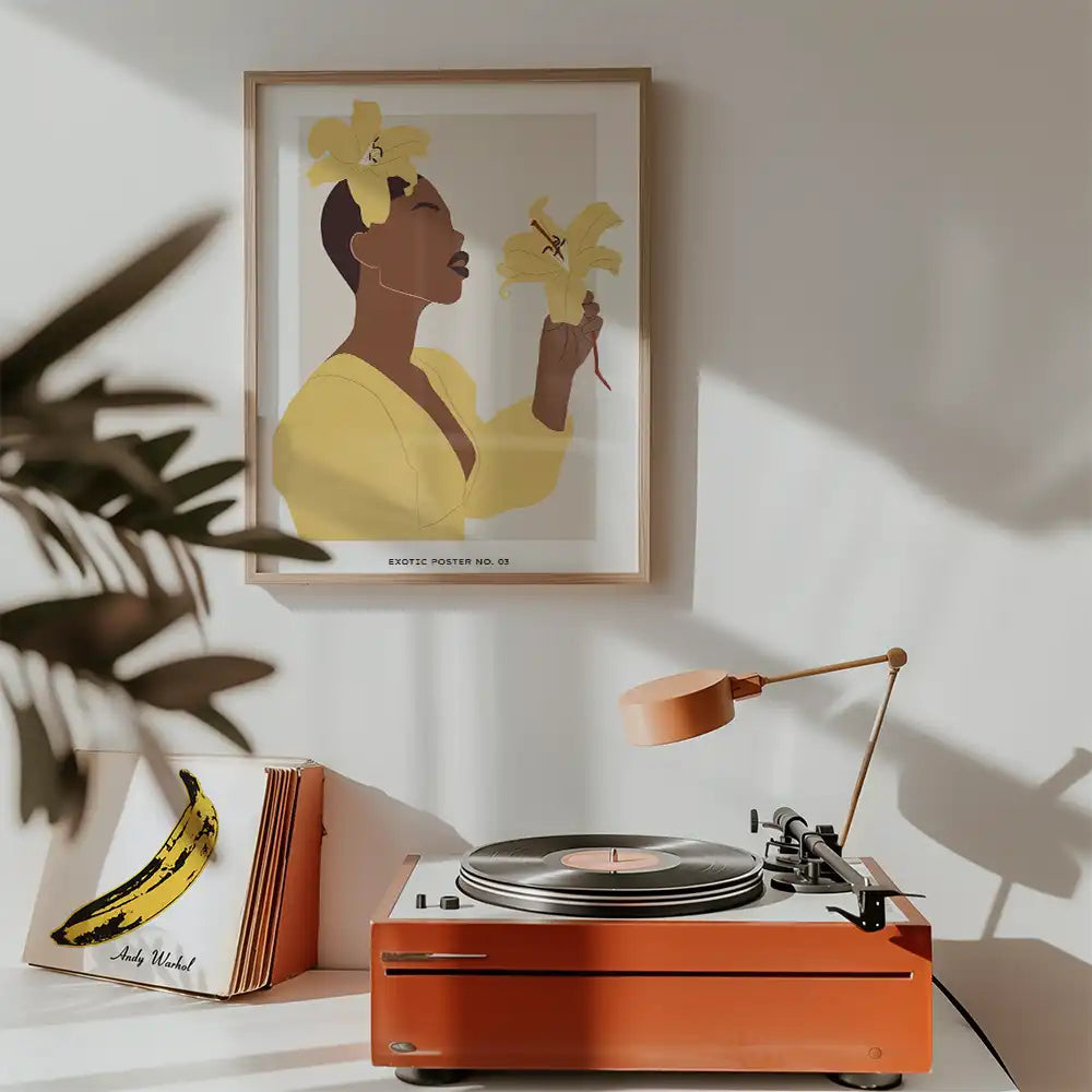 Modern art print featuring a woman in a yellow dress holding yellow flowers, framed and displayed above a vintage record player in a stylish interior setting.