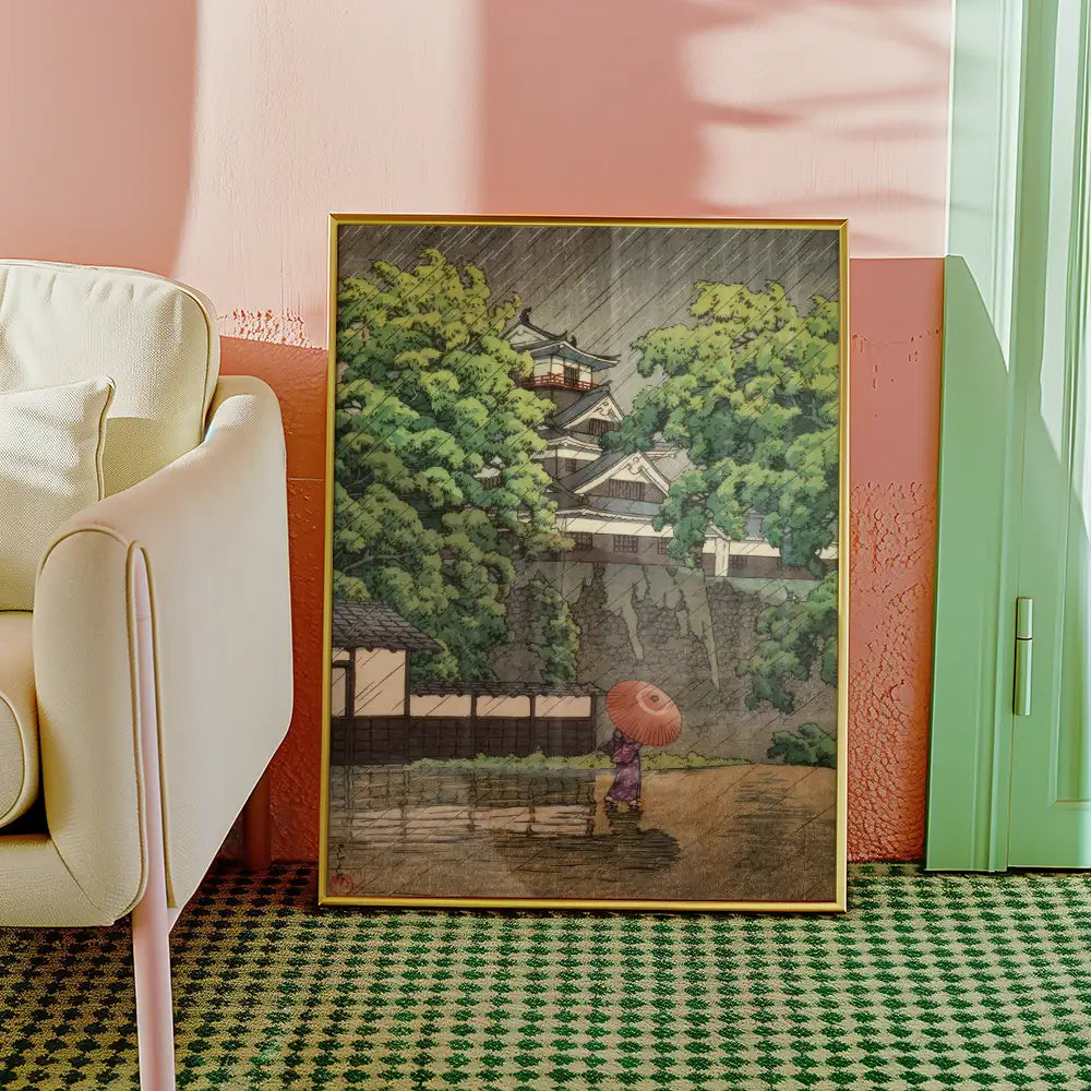 Framed painting of a person with an umbrella walking in the rain surrounded by lush greenery and traditional Japanese architecture.