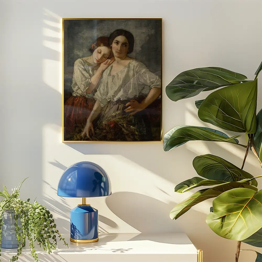 Painting of two women in traditional clothing, framed in gold, displayed on a wall beside a blue table lamp and a leafy plant.