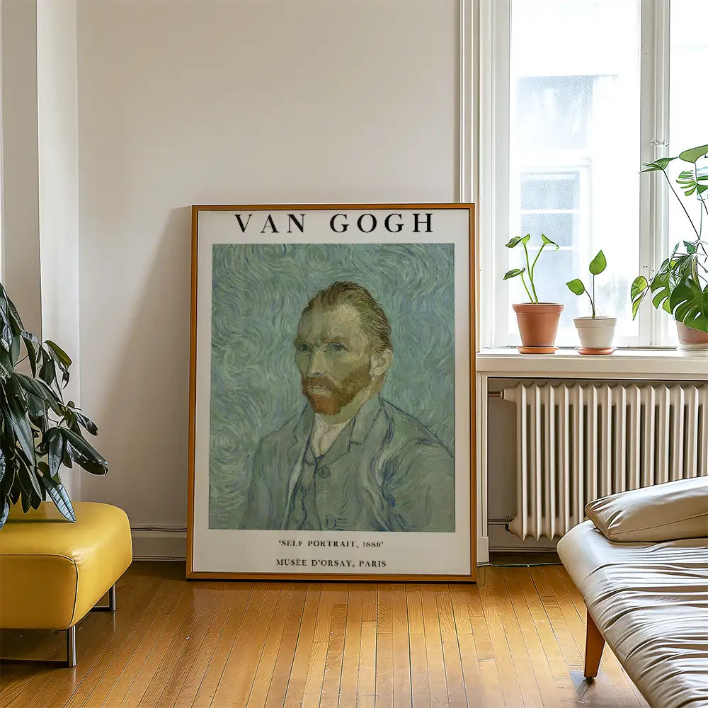 Van Gogh self-portrait painting in a wooden frame displayed in a modern living room with yellow chair and green plants.