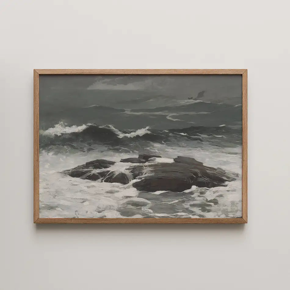 Framed painting of a rocky coastline with crashing waves and a moody gray sky.