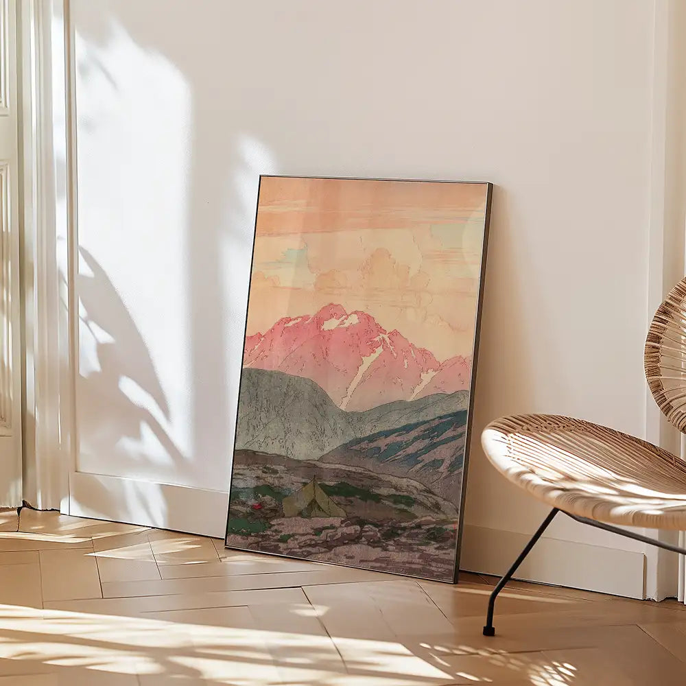 Artistic landscape painting featuring mountains and pastel skies, leaning against a wall in a stylish interior setting.