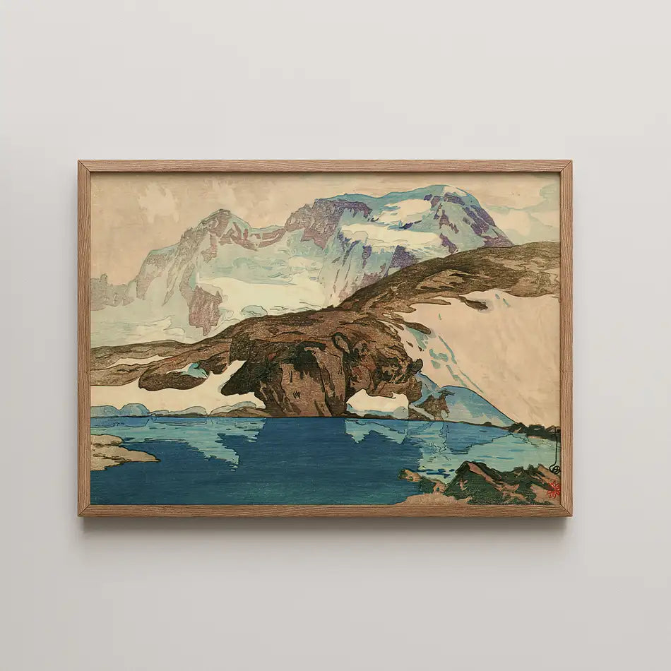 Framed painting of a mountain landscape with a blue lake and snow-capped peaks.