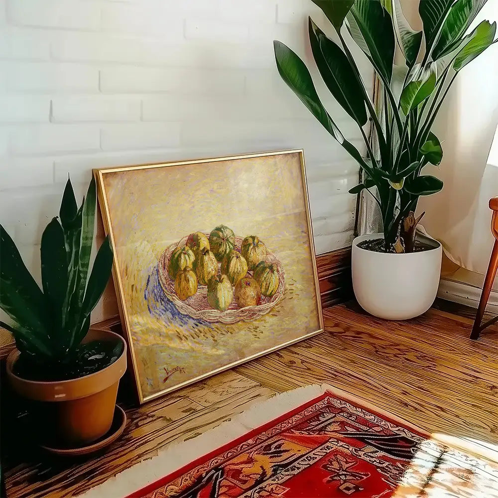 Framed painting of a basket of melons displayed in a sunlit room with green plants and wooden flooring.