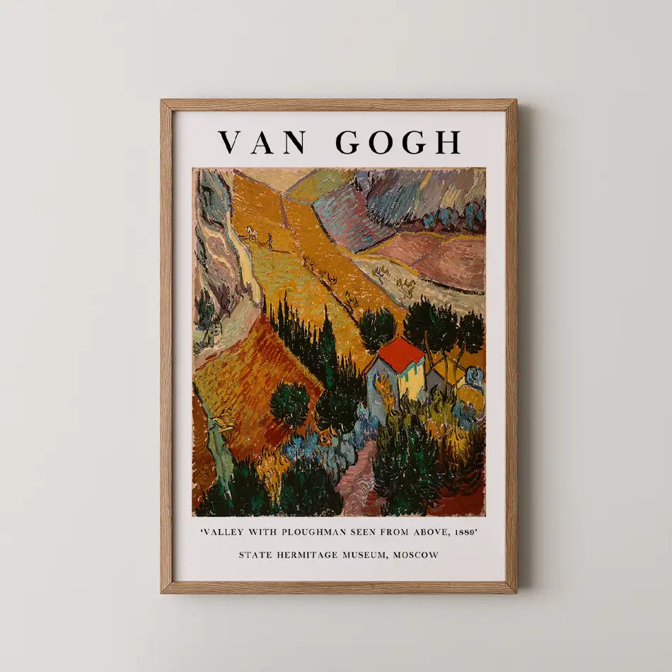 Van Gogh poster titled "Valley with Ploughman Seen from Above, 1889," featuring vibrant fields, trees, and a small house, framed in wood.
