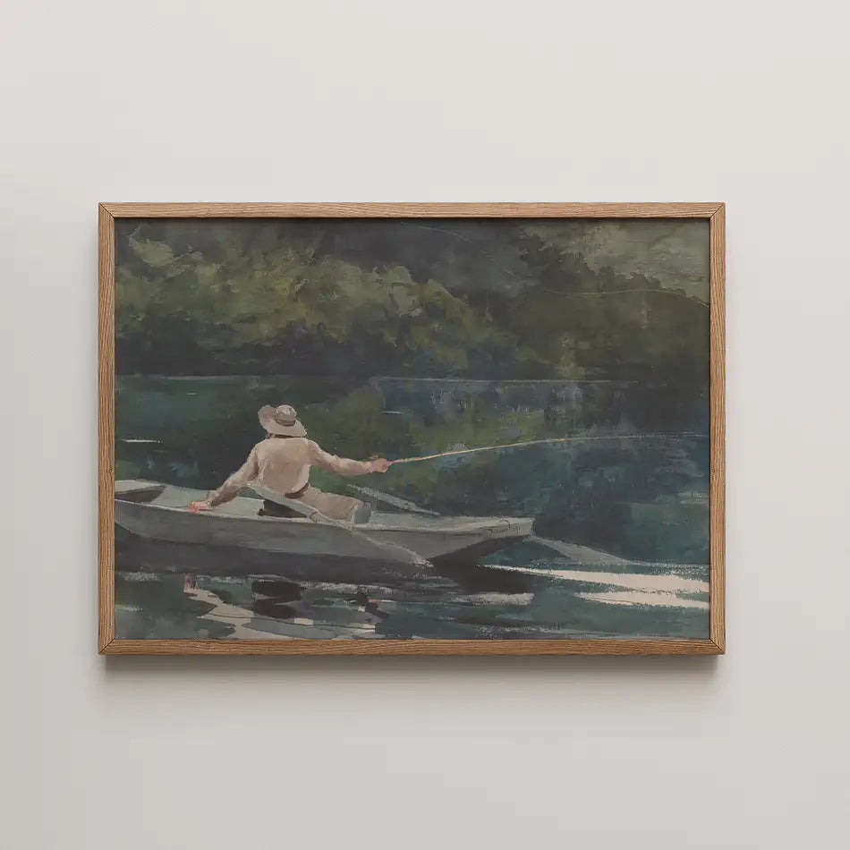 A framed painting of a man fishing from a small boat on calm water surrounded by greenery.