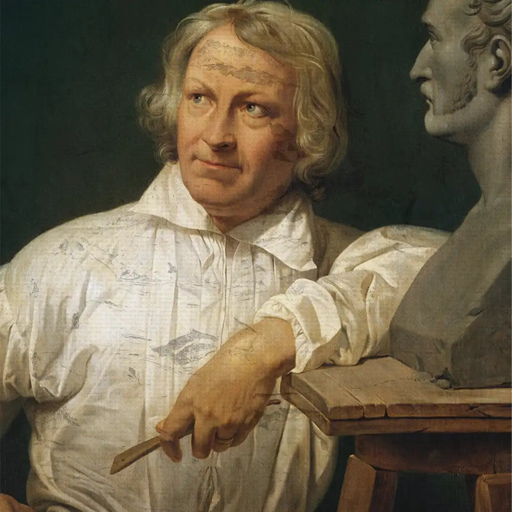 Portrait of a man with long hair in a white shirt, holding a sculptor's tool, beside a bust on a pedestal.
