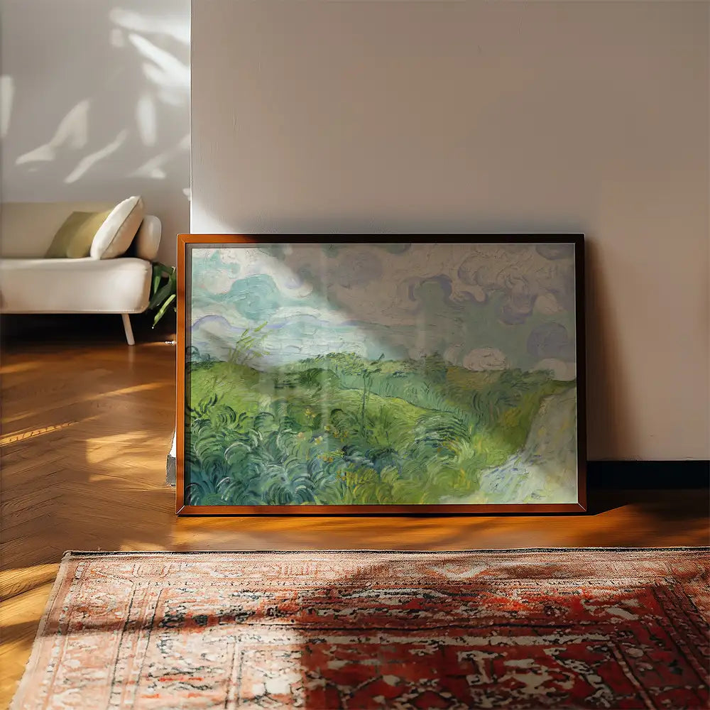 Framed painting of a serene landscape with rolling hills and cloudy skies, positioned against a bright, minimalist interior setting.