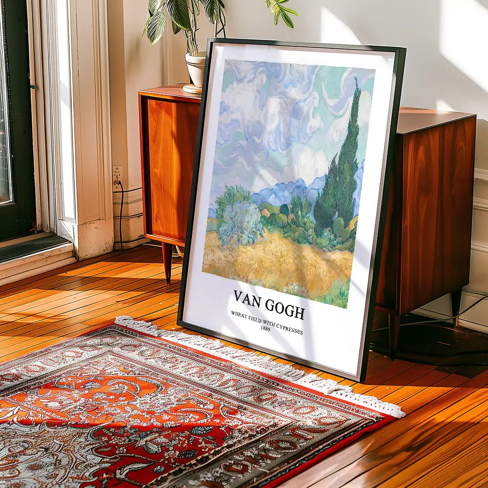 Framed poster of Vincent van Gogh's "Wheat Field with Cypresses" displayed on a wooden floor next to a vintage cabinet and a decorative rug.