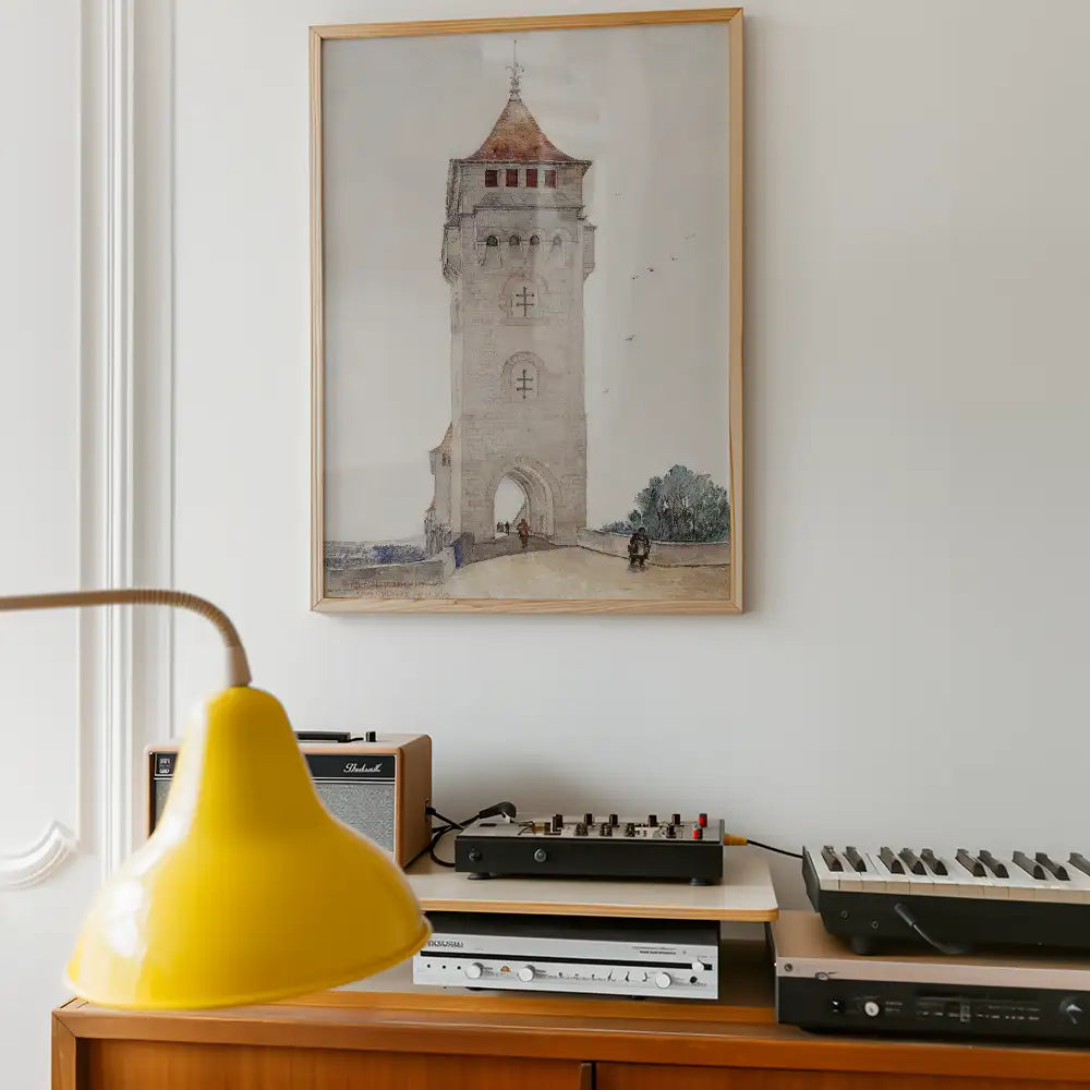 Watercolor painting of a tall tower with a red roof, framed on a wall above a wooden sideboard with a yellow lamp, a vinyl record player, and audio equipment.