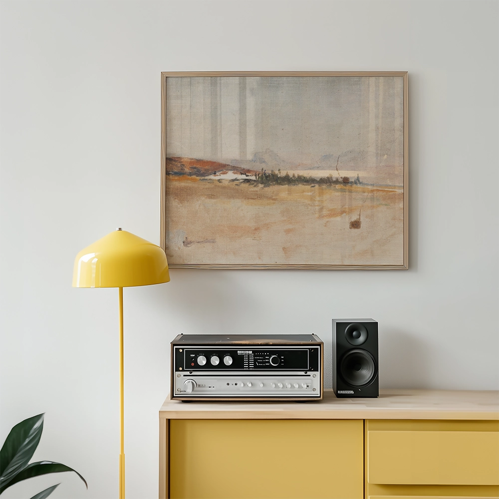 Painting in a wooden frame hanging on a wall above a wooden cabinet with a yellow lamp and a stereo system.