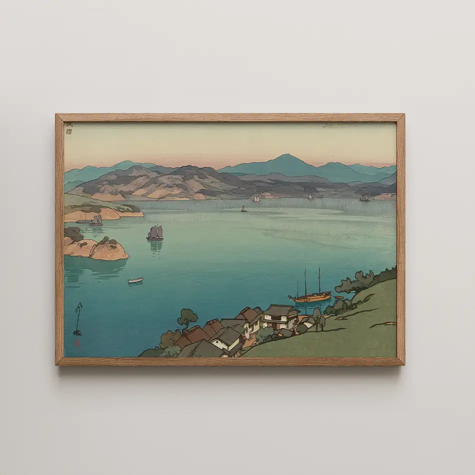 Framed painting of a serene coastal landscape with mountains, calm water, and boats, featuring a blend of soft pastel colors.