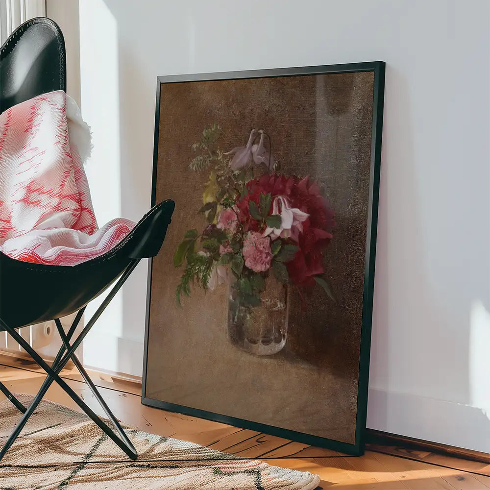 Framed painting of a floral arrangement in a glass vase leaning against a wall, with a black chair and a patterned rug in the background.