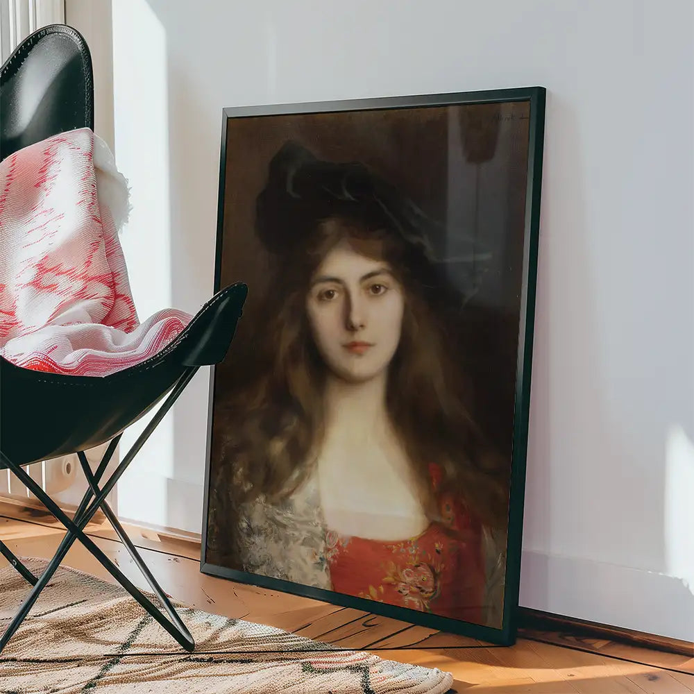 Painting of a woman with long hair, wearing a red dress and a patterned shawl, displayed in a black frame next to a chair and a patterned rug.