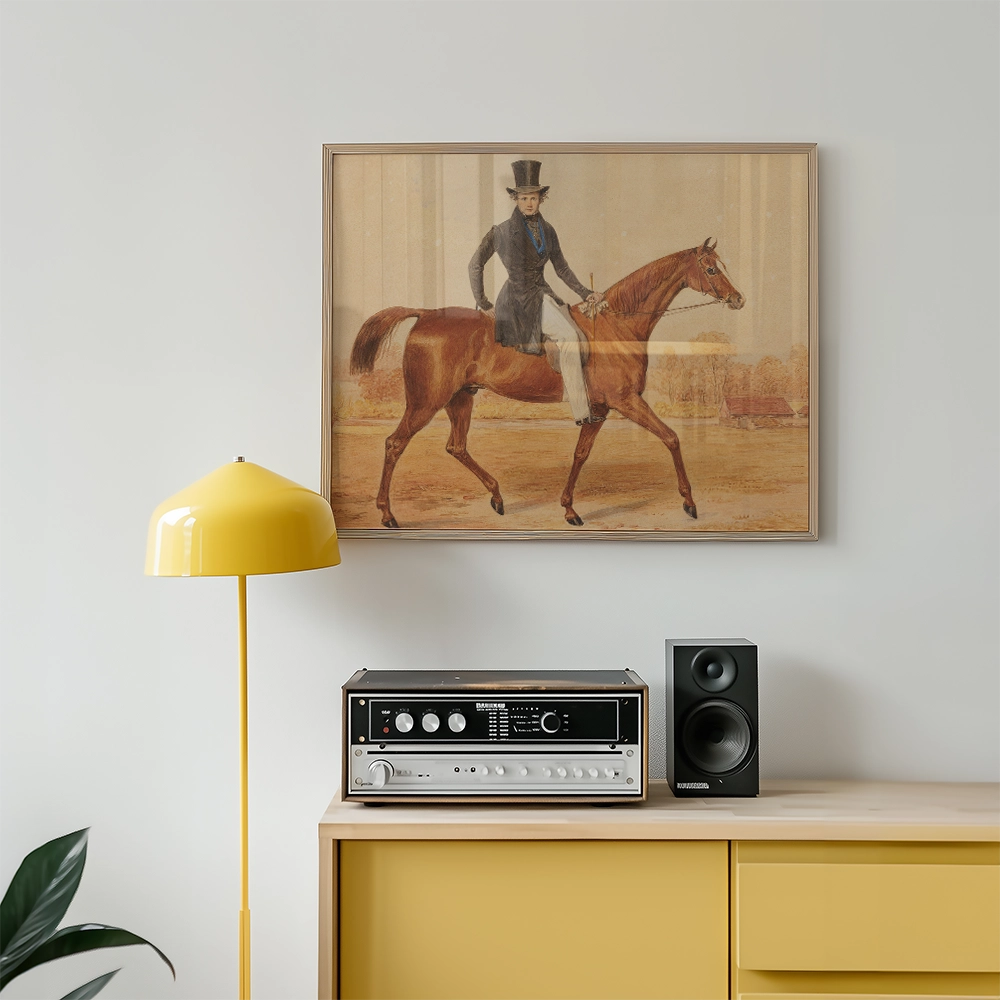 Framed painting of a man in a top hat riding a horse, displayed above a yellow lamp and a vintage audio system on a wooden cabinet.