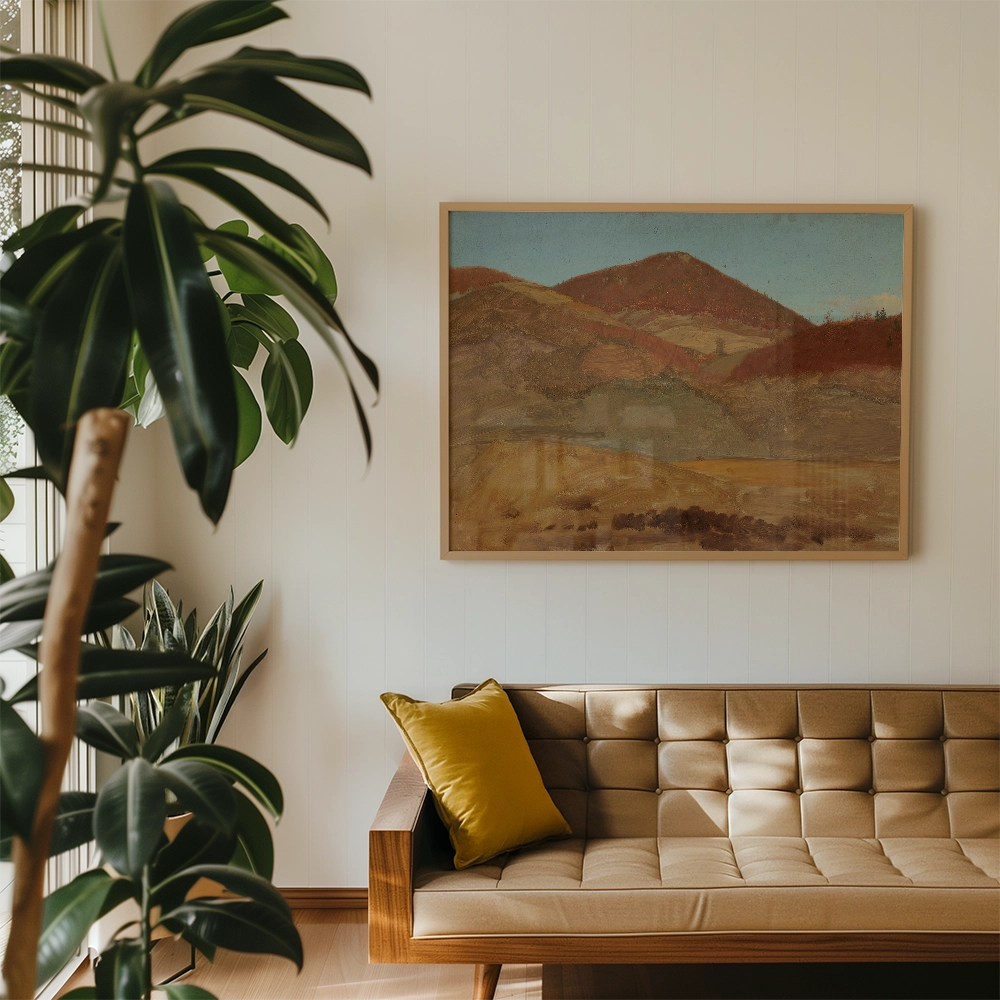 Framed painting of abstract mountains in warm tones, displayed above a stylish mid-century modern sofa with a yellow cushion in a cozy interior setting.