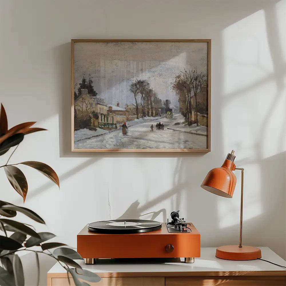 Painting of a winter street scene featuring people walking, framed and displayed above an orange turntable and a matching lamp in a cozy interior setting.