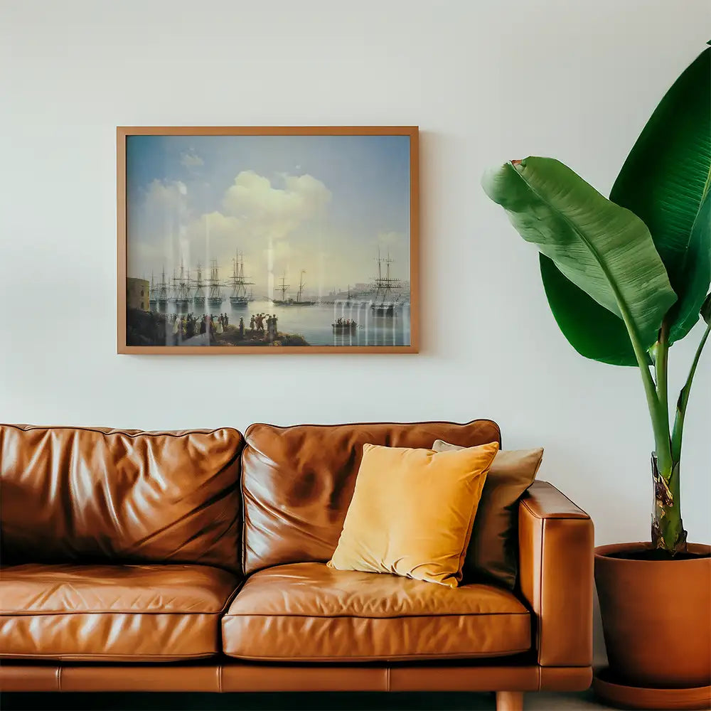 Painting of sailing ships on the water, framed and displayed above a brown leather couch with a yellow cushion, next to a large green plant.