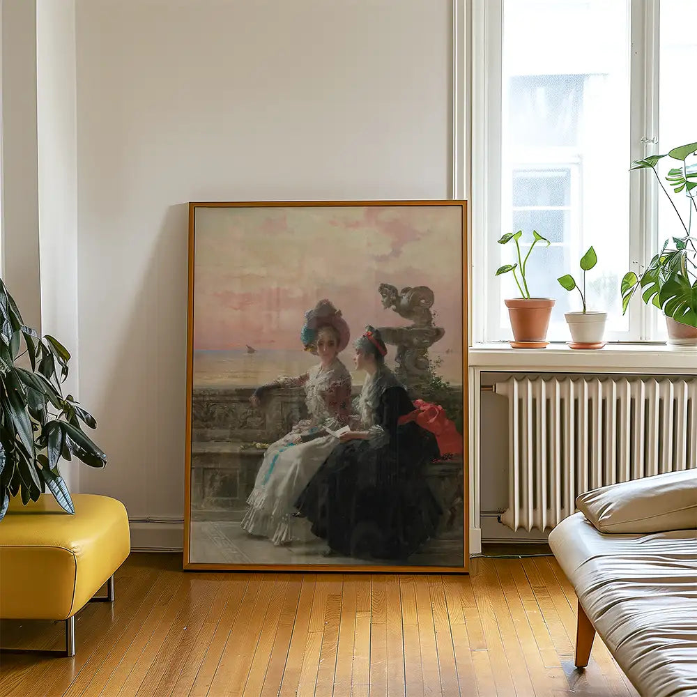 Painting of two elegantly dressed women sitting by the sea, displayed in a modern living room setting with plants and warm wooden floors.