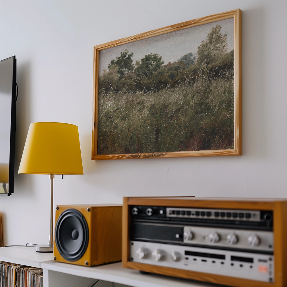 A framed painting of a grassy landscape hanging on a wall next to a yellow lamp and vintage audio equipment.
