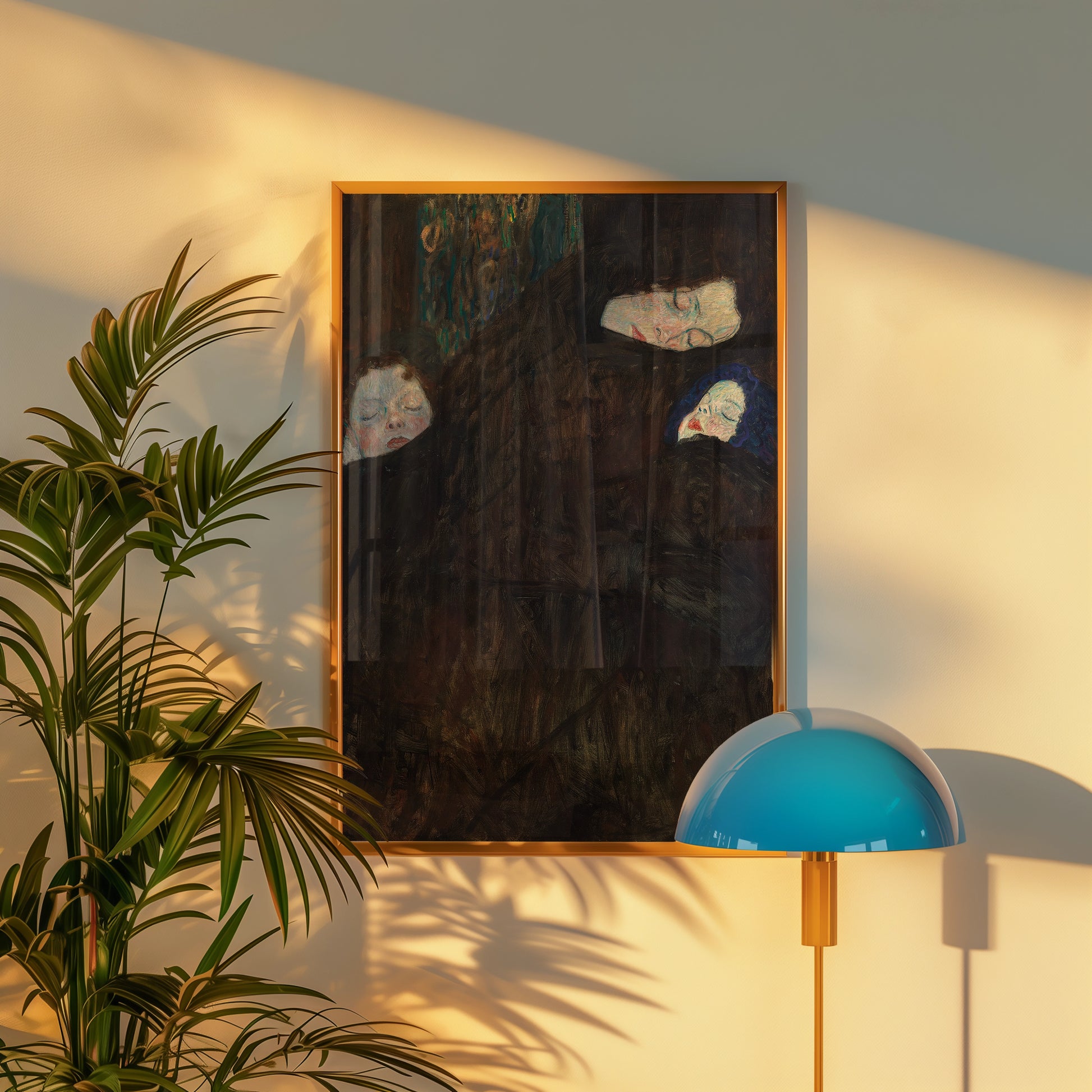 Framed painting of abstract faces in dark tones, displayed on a wall next to a potted plant and a modern blue lamp.