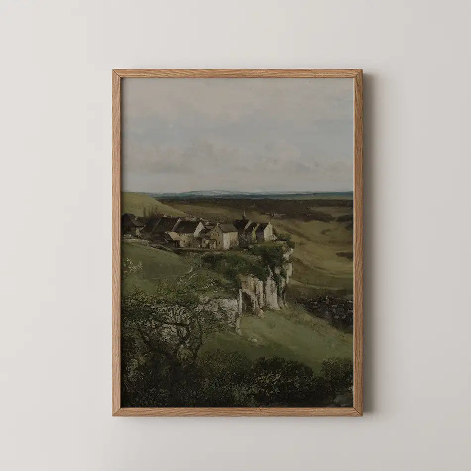 Landscape painting featuring a serene view of houses on a green hillside, framed in a Oak wood frame.