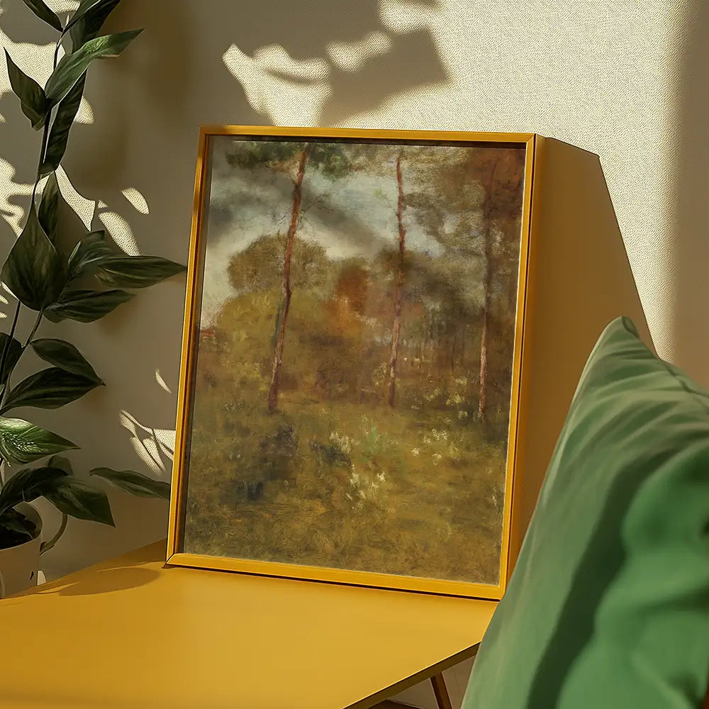 Framed painting of a serene landscape with trees, displayed on a yellow table next to a green cushion and a plant.