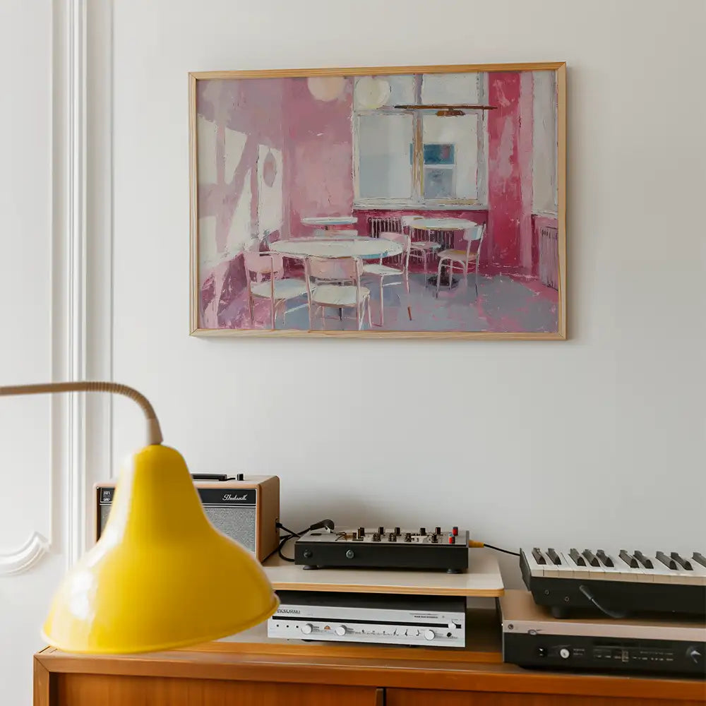 Modern poster reprint of a famous painting featuring a pink-toned interior with tables and chairs, elegantly framed, enhancing contemporary decor.
