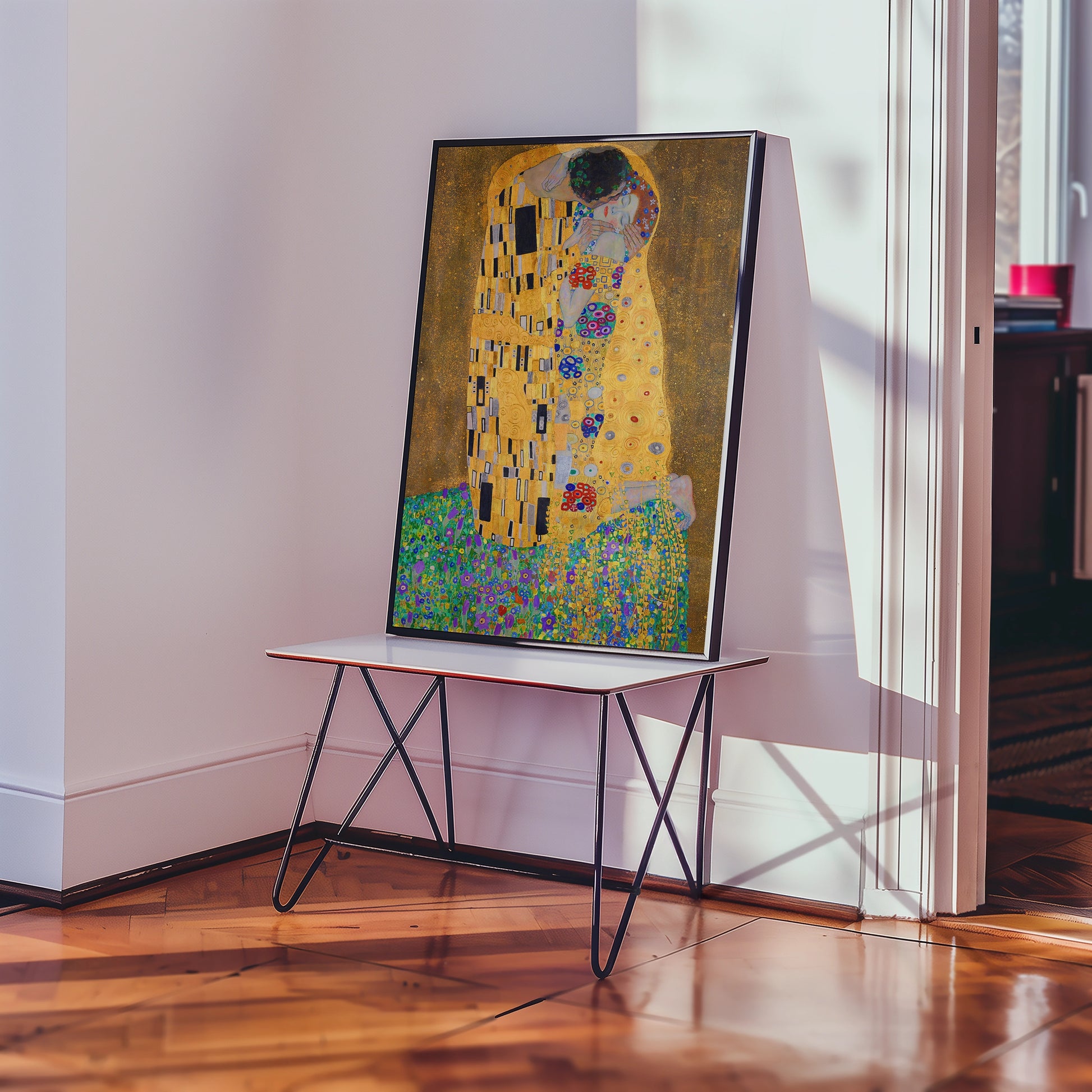 Framed painting of a couple embracing in a colorful and intricate design, displayed on a stylish table in a well-lit interior.