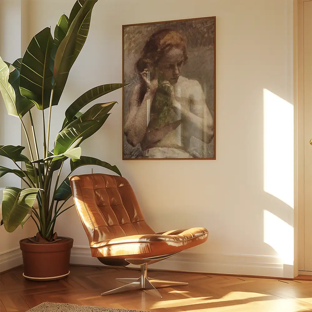 A cozy living space featuring a brown leather chair, a large potted plant, and a framed painting of a serene woman in soft colors, illuminated by natural sunlight.