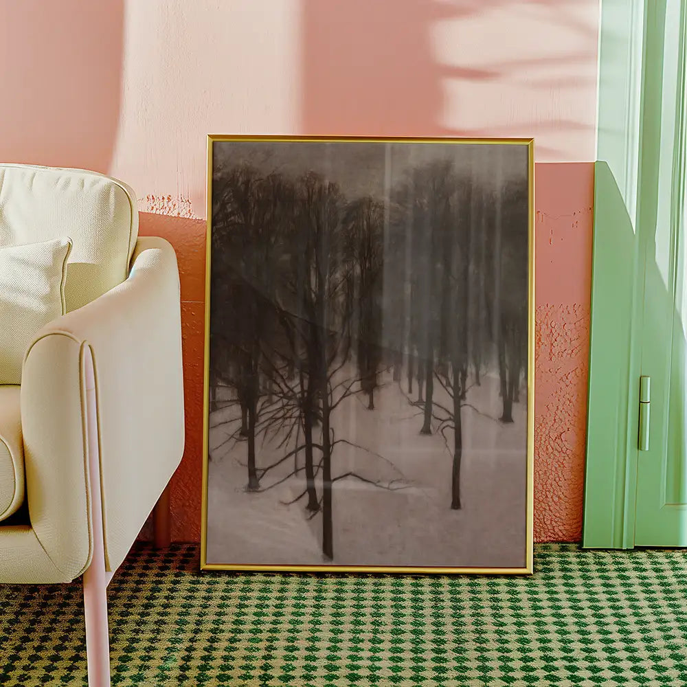A framed painting of a snow-covered forest with dark trees, situated beside a light-colored sofa in a room with pastel-colored walls and a green patterned rug.