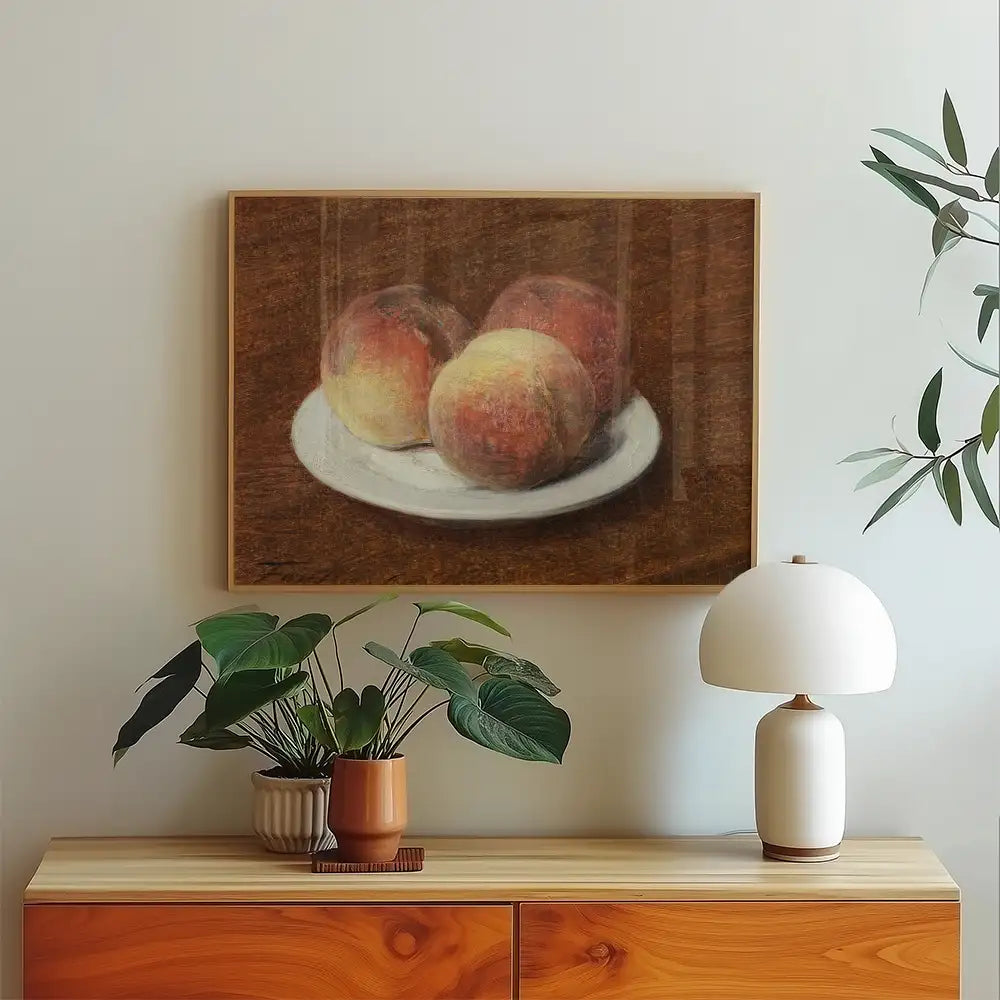 Painting of three peaches on a white plate against a brown background, displayed above a wooden cabinet with a plant and lamp.